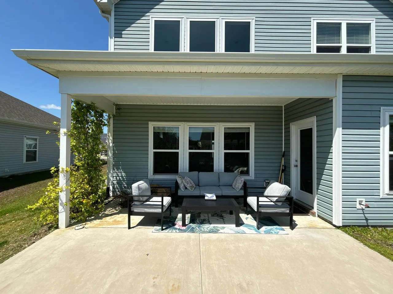 Concrete patio and covered seating before an attached pergola addition in Surfside Beach