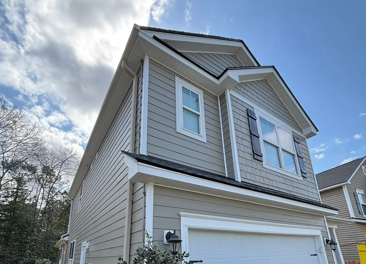 Summerville home with taupe horizontal siding, a shingle-pattern front gable and contrasting white trim