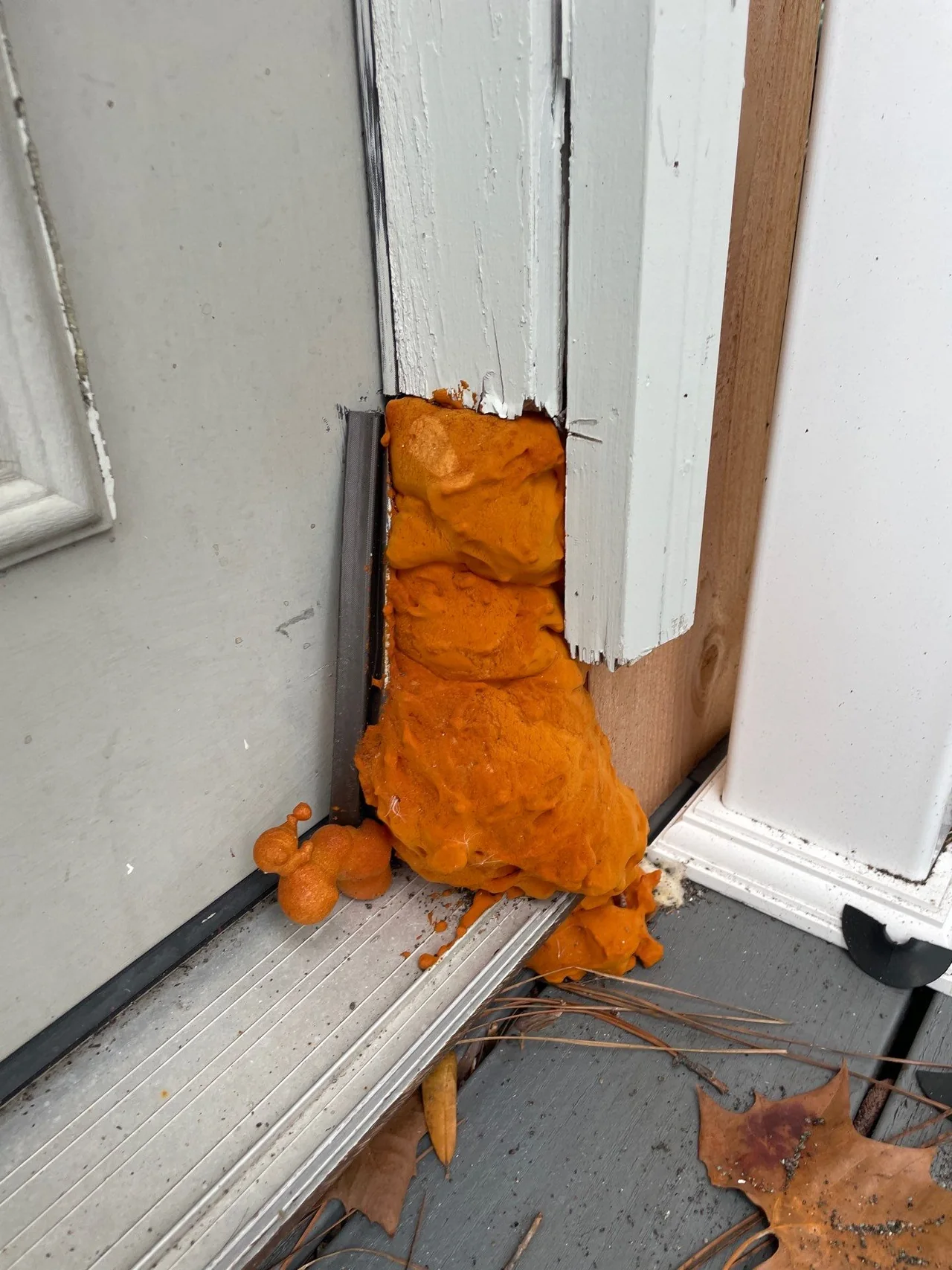 Original lower patio-door frame with exposed foam and deteriorated trim