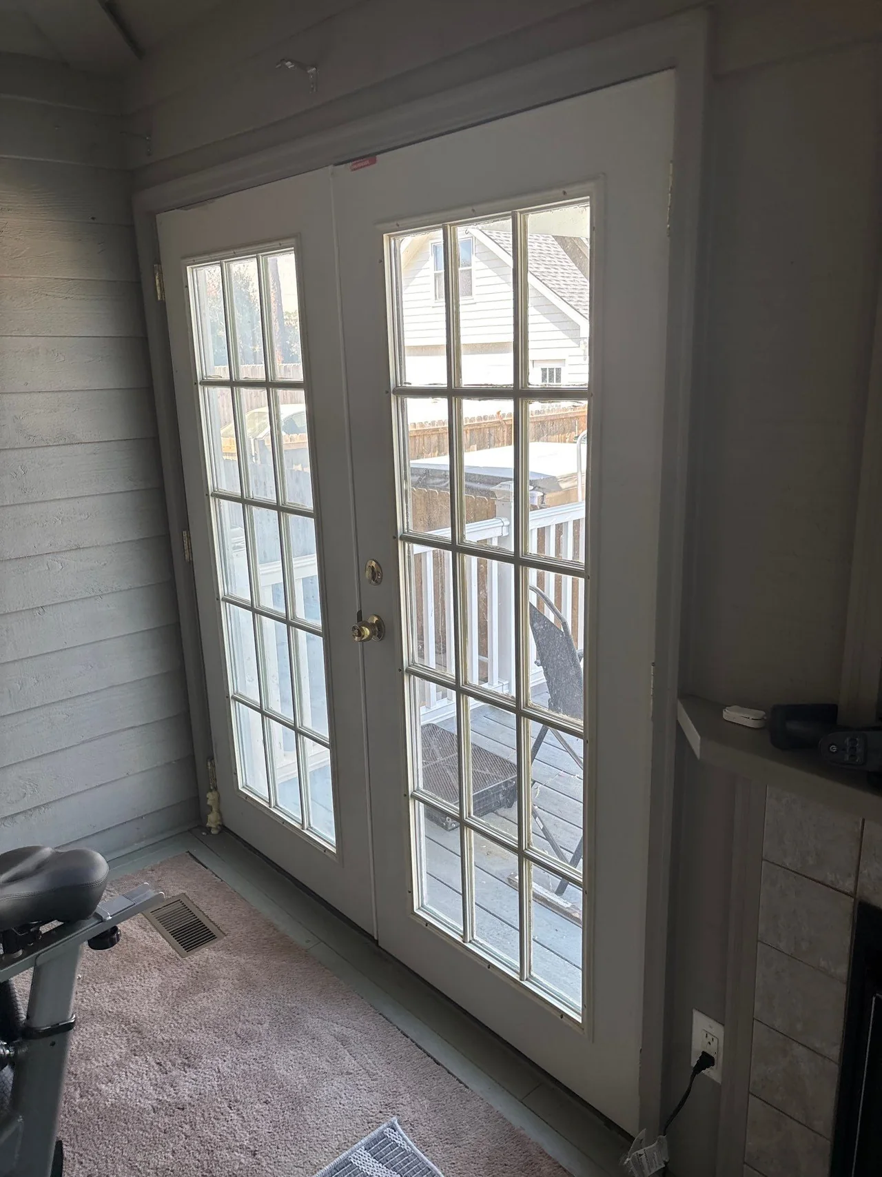 Original hinged glass patio doors leading to the porch