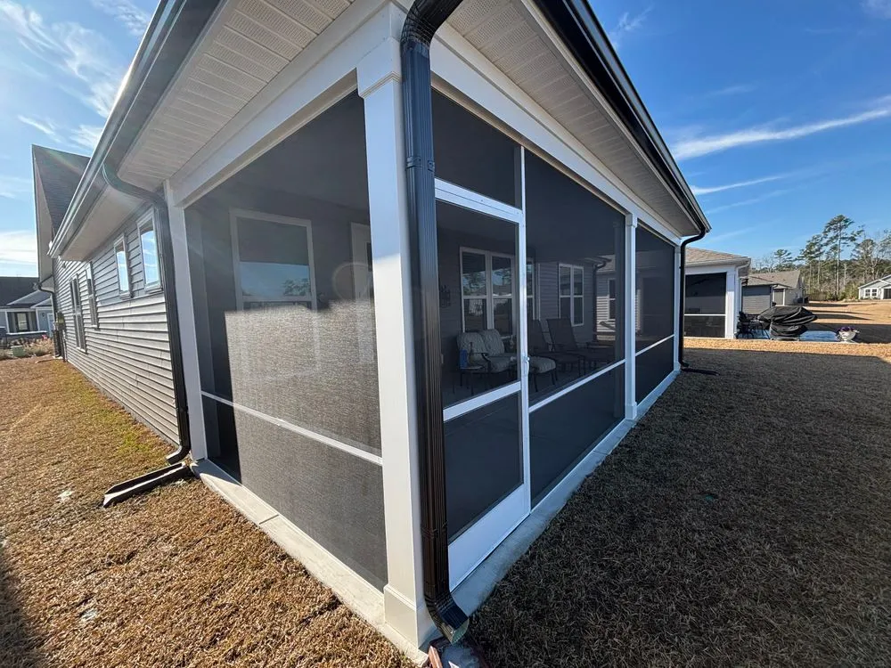 Completed fixed screen enclosure around a covered porch in Myrtle Beach