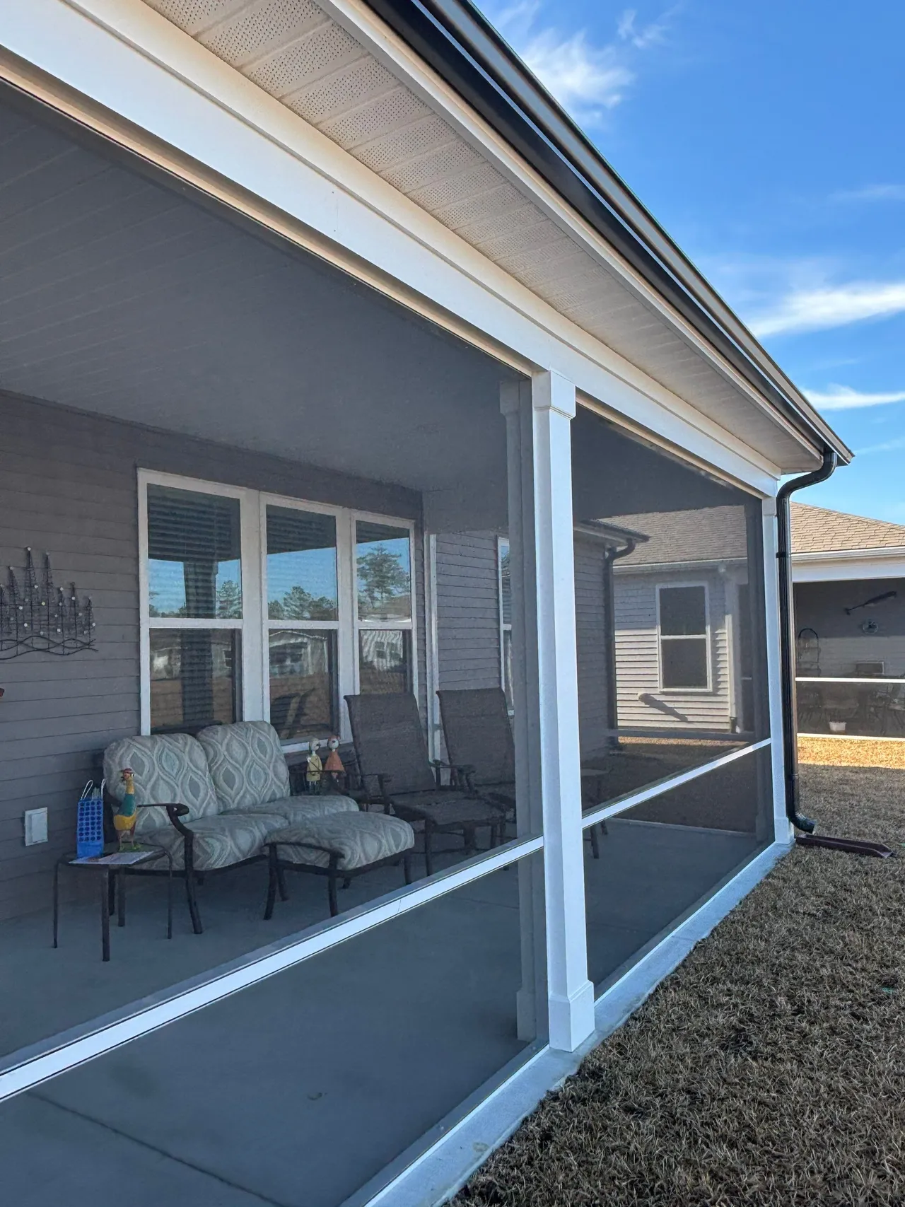 White framing and dark screen panels on the completed Myrtle Beach porch