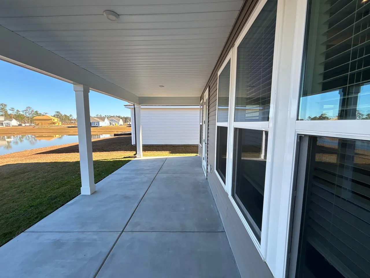 Open-sided covered concrete porch in Myrtle Beach before enclosure