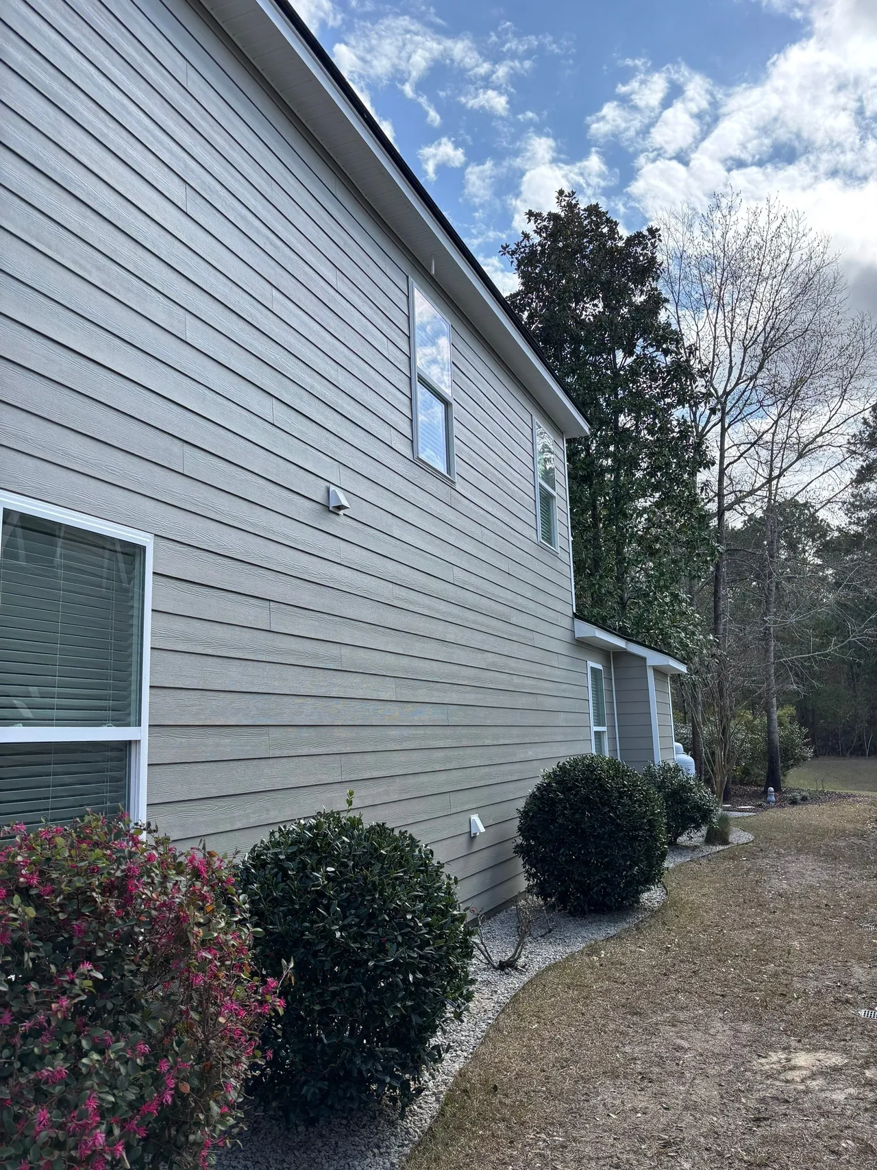 Completed lap siding with white corner and window trim on the Summerville home