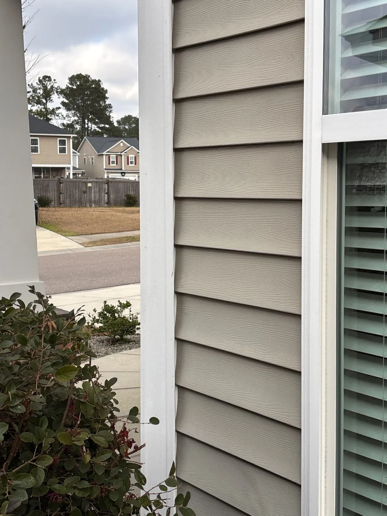 Original siding beside a white window surround and outside corner on the Summerville home
